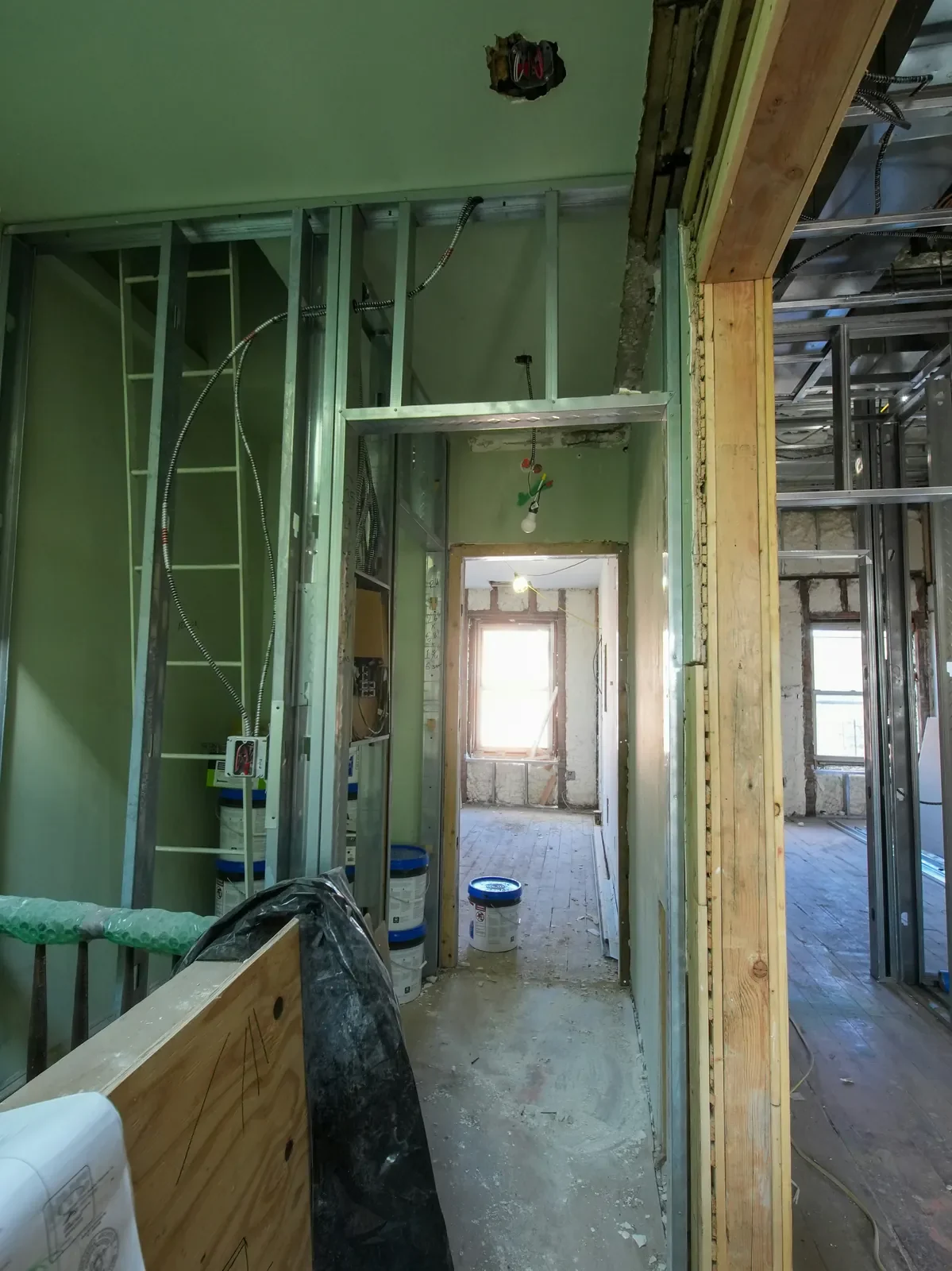 A part-stripped interior with steel stud partitions and board still standing